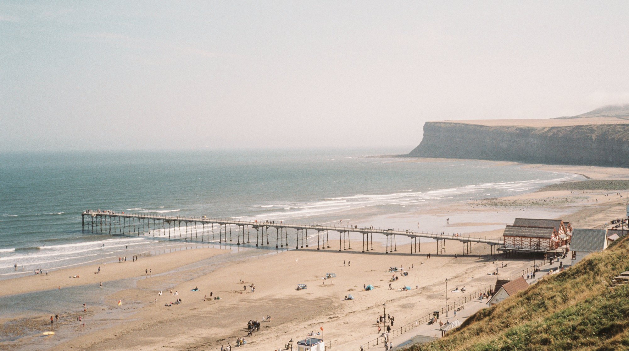 Saltburn pier and beach from the cliff, Huntcliff in the distance